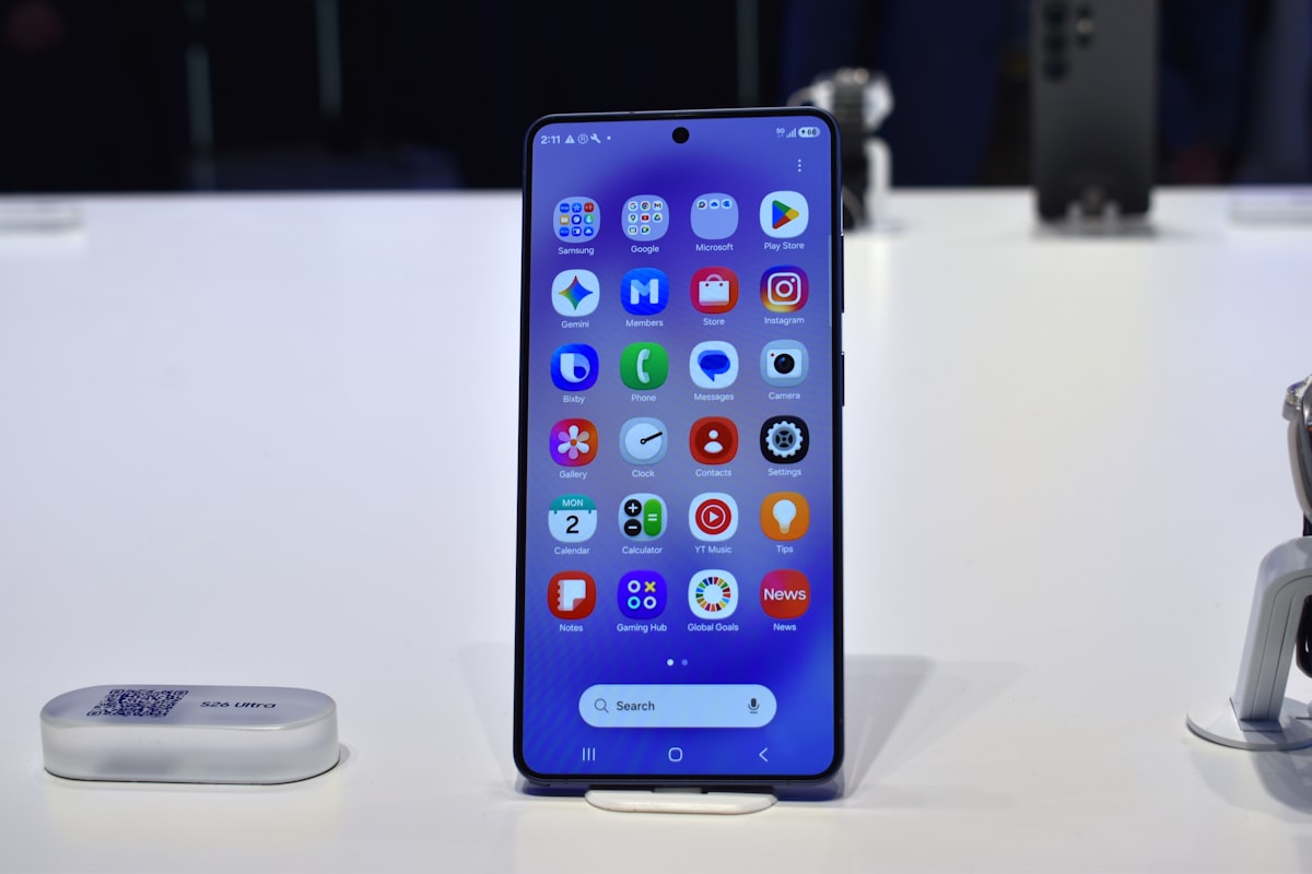 Hands holding a phone with app icons on screen